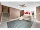 A cozy living room with tile flooring, a staircase, and an open view into the kitchen at 7023 Hartington Pl, Indianapolis, IN 46259
