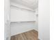 A walk-in closet features ample storage space with shelving and hanging racks for organizing clothes and accessories at 7023 Hartington Pl, Indianapolis, IN 46259