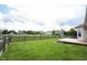 Backyard featuring a large grassy area enclosed by a wood fence and a small wood deck at 7131 Blue Ridge Dr, Noblesville, IN 46062