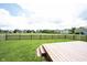 Backyard featuring a large grassy area enclosed by a wood fence and a small wood deck at 7131 Blue Ridge Dr, Noblesville, IN 46062
