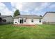 Back of house with sliding glass doors to a wooden deck overlooking the green backyard at 7131 Blue Ridge Dr, Noblesville, IN 46062