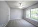 Cozy bedroom with neutral carpet, a ceiling fan and a sun-filled window at 7131 Blue Ridge Dr, Noblesville, IN 46062