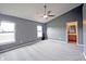 Light-filled bedroom with plush carpet, two windows, ceiling fan, and ensuite bathroom access at 7131 Blue Ridge Dr, Noblesville, IN 46062