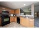 Clean kitchen design highlighting black appliances, countertops and eat-in breakfast bar at 7131 Blue Ridge Dr, Noblesville, IN 46062