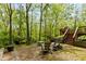 Inviting backyard brick patio with a seating area and scenic views of a lush, wooded landscape at 7189 Creekwood Estates, Brownsburg, IN 46112