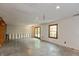 Unfinished basement offers a blank canvas with a window, walk-out door, and exposed framing at 7189 Creekwood Estates, Brownsburg, IN 46112