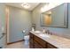 Clean bathroom with a granite countertop, wooden vanity, and a large mirror, providing a fresh, modern look at 7189 Creekwood Estates, Brownsburg, IN 46112