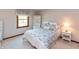 Comfortable bedroom with a floral patterned bedspread, neutral walls, and a bright window at 7189 Creekwood Estates, Brownsburg, IN 46112