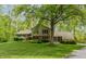 Charming single-story home featuring a brick and siding exterior, lush landscaping, and a well-maintained lawn at 7189 Creekwood Estates, Brownsburg, IN 46112