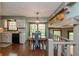 Open floor plan featuring the kitchen and dining area with a unique chandelier at 7189 Creekwood Estates, Brownsburg, IN 46112