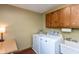 Laundry room featuring a sink, washer, dryer, and wooden cabinets at 7189 Creekwood Estates, Brownsburg, IN 46112