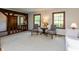 Neutral living room showcasing hardwood trim, a decorative table, and a large picture window at 7189 Creekwood Estates, Brownsburg, IN 46112