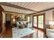 Bright living room featuring a comfortable sectional, area rug, and sliding doors to the outside at 7189 Creekwood Estates, Brownsburg, IN 46112