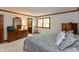 Cozy main bedroom boasts wood trim, a spacious dresser, and a comfortable rocking chair at 7189 Creekwood Estates, Brownsburg, IN 46112