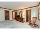 Spacious main bedroom featuring wood trim, a dresser with mirror, and multiple entrances at 7189 Creekwood Estates, Brownsburg, IN 46112