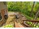 Patio with outdoor seating and fire pit overlooking a yard with mature trees, beautiful greenery, and a charming creek at 7189 Creekwood Estates, Brownsburg, IN 46112