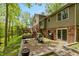 A stunning brick patio with a gas grill, outdoor seating and a fire pit and brick patio area with access to the wood deck above at 7189 Creekwood Estates, Brownsburg, IN 46112