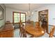 Elegant dining room features a chandelier, wood table, and chairs, creating a warm and inviting space at 7189 Creekwood Estates, Brownsburg, IN 46112
