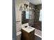 Stylish bathroom featuring modern tiling, a vanity with a white sink, and updated fixtures for a spa-like experience at 7334 Westchester Dr, Indianapolis, IN 46226