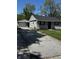 Quaint single-story home featuring gray siding, a dark roof, and a detached garage, offering cozy living at 7334 Westchester Dr, Indianapolis, IN 46226