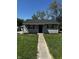 Charming single-story home featuring gray siding, a dark roof, and well-maintained front lawn at 7334 Westchester Dr, Indianapolis, IN 46226
