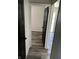 Hallway view with wood-look flooring, showcasing the transition between rooms and the home's interior design at 7334 Westchester Dr, Indianapolis, IN 46226