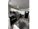 Bright kitchen boasting stainless steel appliances, white upper cabinets, and black lower cabinets for a modern touch at 7334 Westchester Dr, Indianapolis, IN 46226