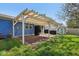 View of the backyard featuring a covered patio, shed, and a well-maintained lawn at 7645 Madden Dr, Fishers, IN 46038