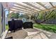 Backyard features a covered patio and a grill with plenty of green space and mature trees at 7645 Madden Dr, Fishers, IN 46038