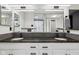 Spacious primary bathroom with double vanity, dark granite counters, and sleek, modern faucets at 7645 Madden Dr, Fishers, IN 46038