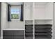 Bright closet features window, drawers, shelves and wire basket organizers for optimal storage at 7645 Madden Dr, Fishers, IN 46038