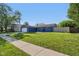 View of the house from the street showing the lawn, driveway, and landscaping at 7645 Madden Dr, Fishers, IN 46038