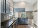 This kitchen features blue cabinets, granite countertops, and a stainless steel dishwasher and sink at 7645 Madden Dr, Fishers, IN 46038