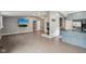 Bright living room and kitchen featuring fireplace, vinyl floors, television, blue cabinets, granite countertops at 7645 Madden Dr, Fishers, IN 46038