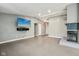Bright living room featuring fireplace, vinyl floors, mounted television, and neutral walls at 7645 Madden Dr, Fishers, IN 46038