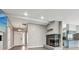 Living room featuring a fireplace, modern light fixtures, and an open layout to the entryway at 7645 Madden Dr, Fishers, IN 46038