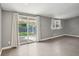 Bright living room features sliding glass doors to a pergola-covered patio and backyard at 7645 Madden Dr, Fishers, IN 46038