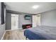 Main bedroom features hardwood floors, TV on the wall, and an open ensuite bathroom at 7645 Madden Dr, Fishers, IN 46038