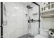 Beautiful walk-in shower features black fixtures, white marble tile, and stylish corner shelving at 7645 Madden Dr, Fishers, IN 46038