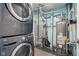 Utility room featuring a stacked washer/dryer, water heater, and other mechanical components at 7645 Madden Dr, Fishers, IN 46038