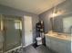Well-lit bathroom featuring a shower with glass door, a modern vanity, and updated fixtures, creating a functional space at 7764 Hollybrook Ln, Southport, IN 46227