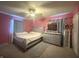 Spacious bedroom with a ceiling fan, complemented by large windows and modern furnishings, creating a peaceful retreat at 7764 Hollybrook Ln, Southport, IN 46227