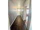 Inviting hallway with tiled flooring and neutral walls, leading to a bright doorway, offering a sense of spaciousness at 7764 Hollybrook Ln, Southport, IN 46227