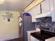 This kitchen has updated stainless steel appliances, modern cabinetry, and stylish backsplash, providing a welcoming space at 7764 Hollybrook Ln, Southport, IN 46227