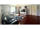 Spacious living room featuring modern furniture, hardwood floors, and a large window at 7764 Hollybrook Ln, Southport, IN 46227
