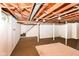 Spacious unfinished basement area with exposed ceiling, painted walls, and access to stairs at 7849 E 49Th St, Indianapolis, IN 46226