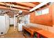 Unfinished basement offers laundry area, workbench, and pegboard on painted walls at 7849 E 49Th St, Indianapolis, IN 46226