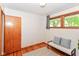 Bedroom featuring wood floors, a window and bench at 7849 E 49Th St, Indianapolis, IN 46226