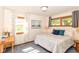 Comfortable bedroom with ample natural light, featuring a queen bed, wooden desk, and neutral decor at 7849 E 49Th St, Indianapolis, IN 46226
