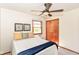 Well-lit bedroom featuring a ceiling fan, two windows, and hardwood trim at 7849 E 49Th St, Indianapolis, IN 46226